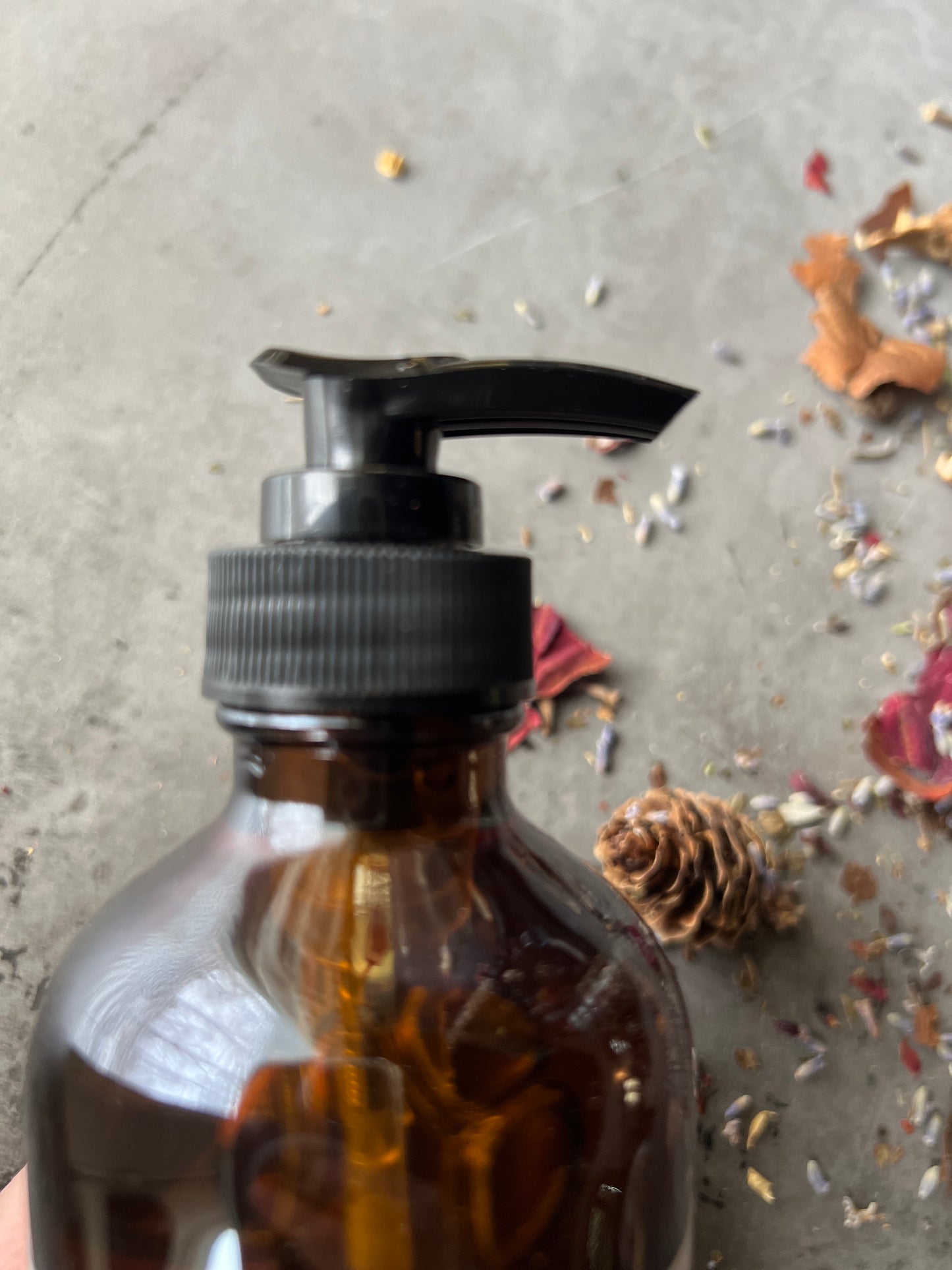 A close up of the black pump top for the hand soap bottle